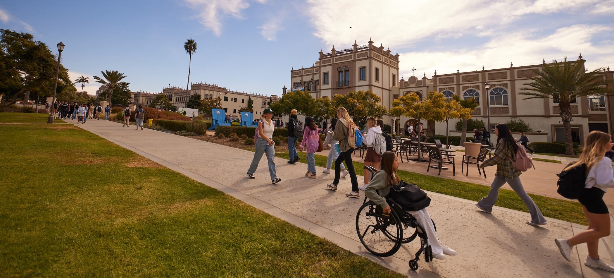 USD students walking side by side through campus