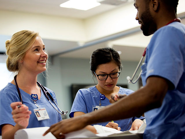 Students talk in a nursing class