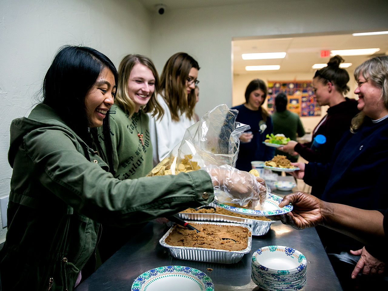 Students distribute food at an event on the USD campus