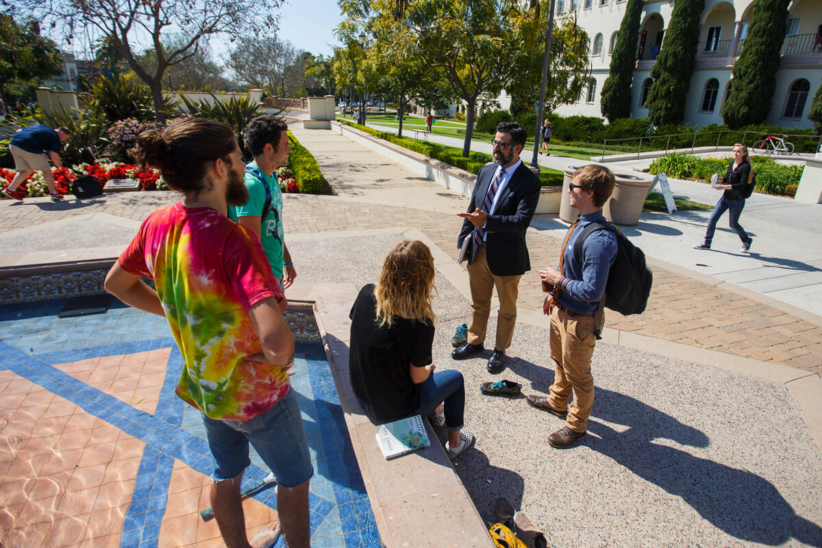 students talking at fountain