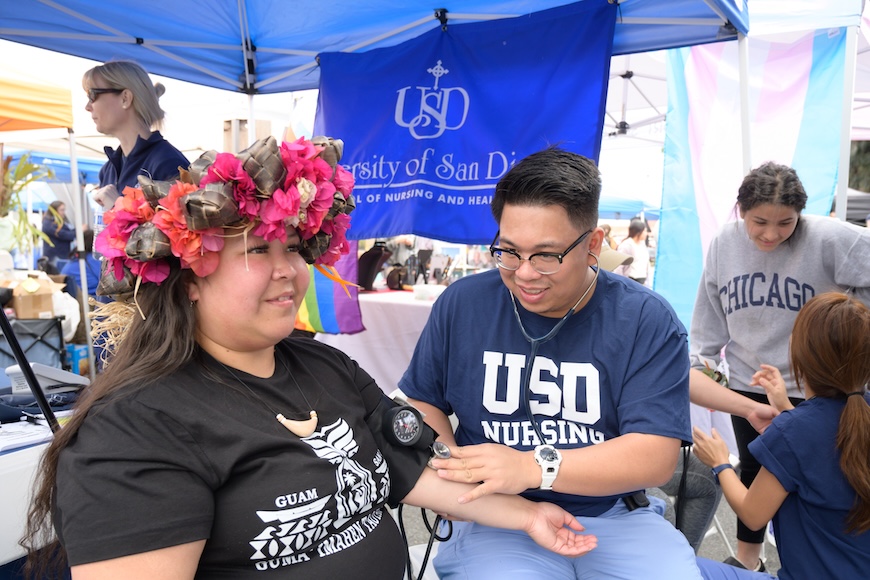 A USD School of Nursing student administers a blood pressure test during the 2025 Linda Vista Multi-Cultural Fair and Parade (Photo: Lauren Radack)