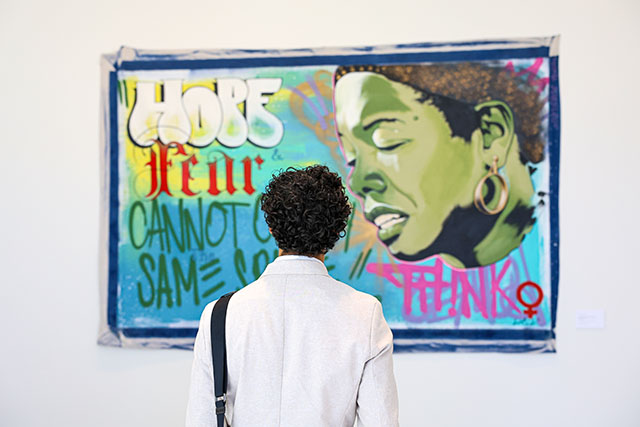 Cristian looks at artwork in the new Palomar Health Student Wellness Center