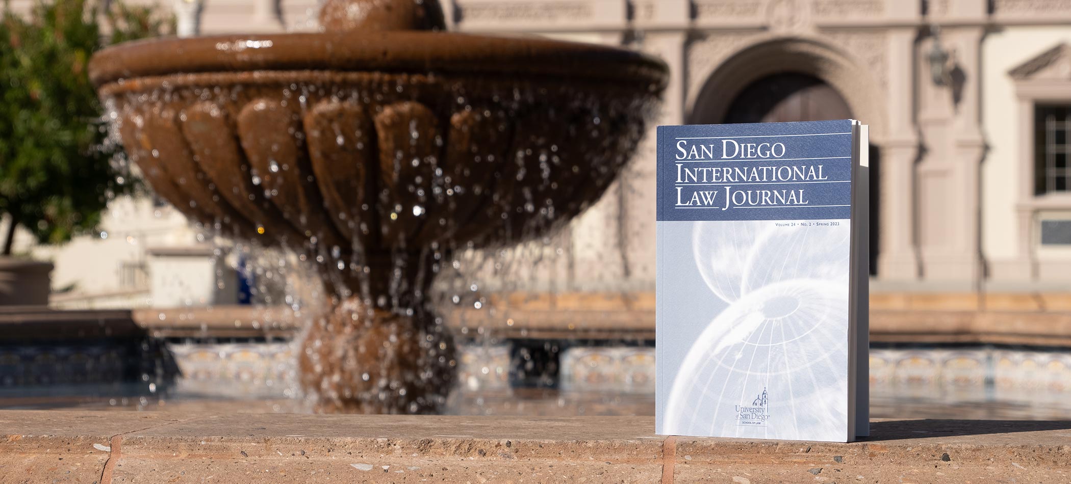 A copy of the ILJ by the fountain at USD