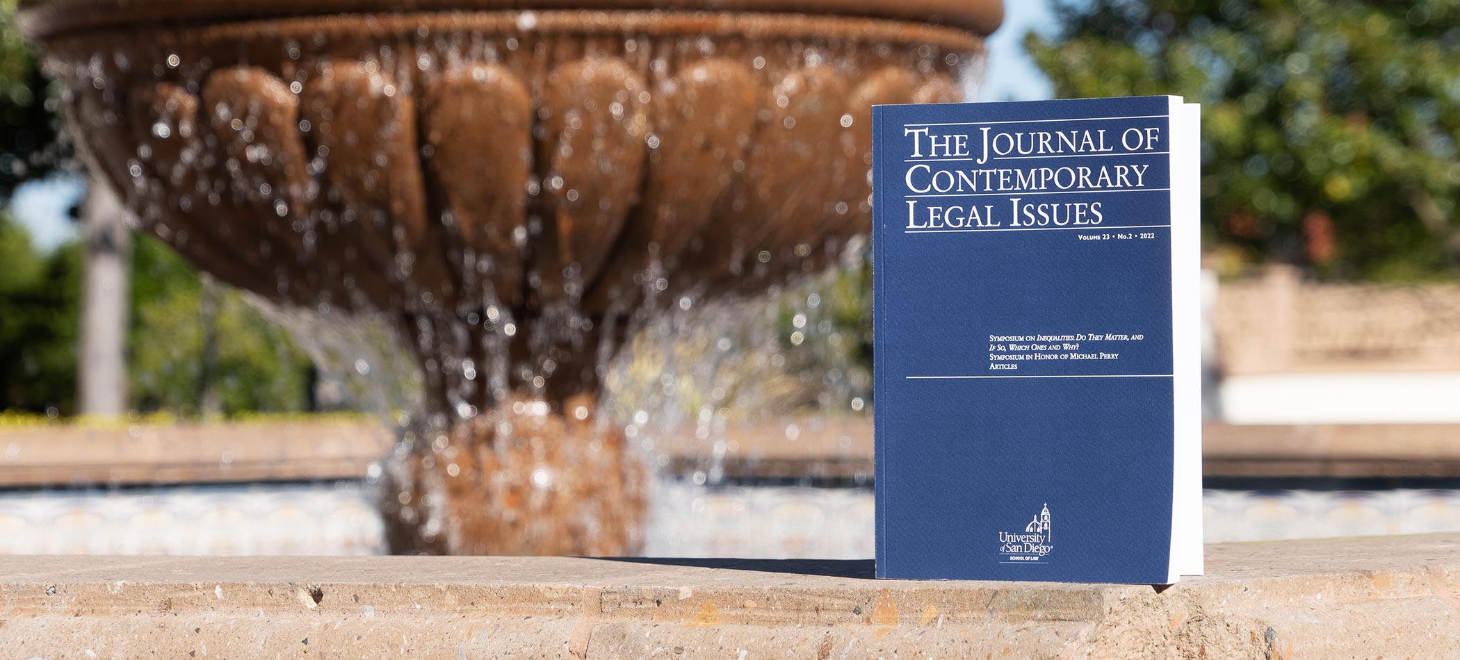 A copy of the JCLI by one of the fountains on the USD campus