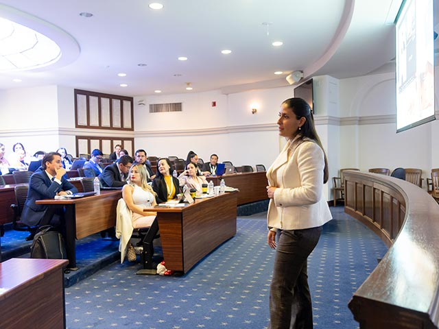 A law professor reading a book at a table