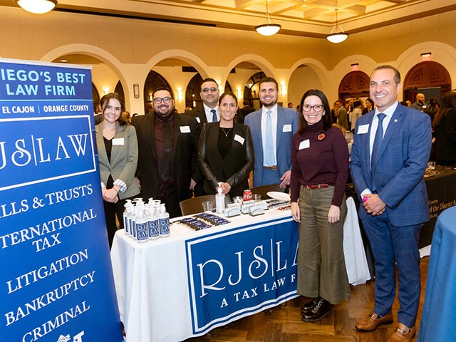 Members of the RJS law team posing in front of their table at a career fair