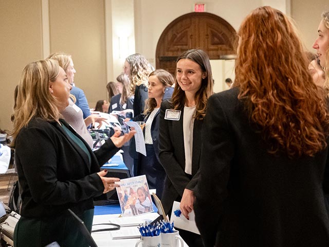 A student talking to an employer at a career fair