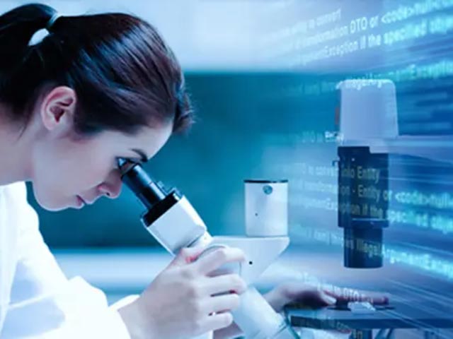 person looking through microscope
