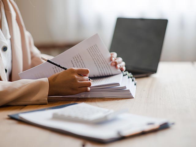 A person writing on some paper
