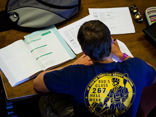 A study writing in a notebook