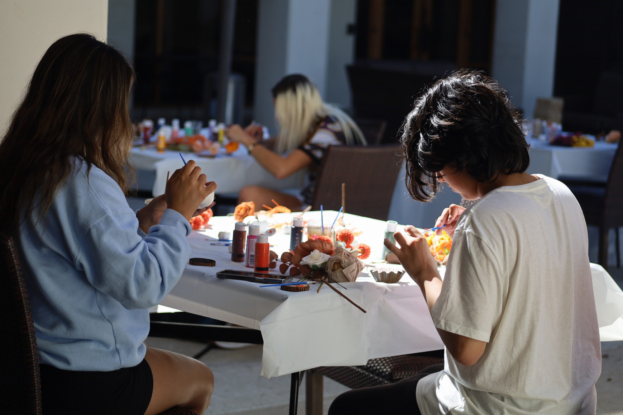 Picture of students painting pumpkins at Nothing Bundt Love for Transfers event