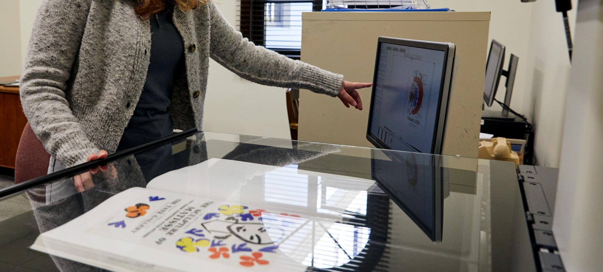 Someone pointing at a computer