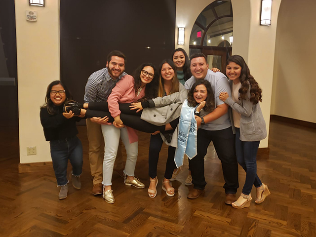 Student leaders carrying a graduating team member.