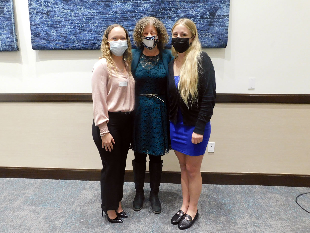Two student event organizers with Mortar Board faculty advisor