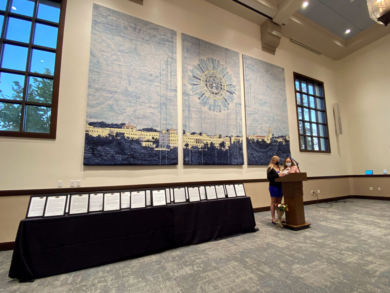 Podium and table lined with framed faculty tributes