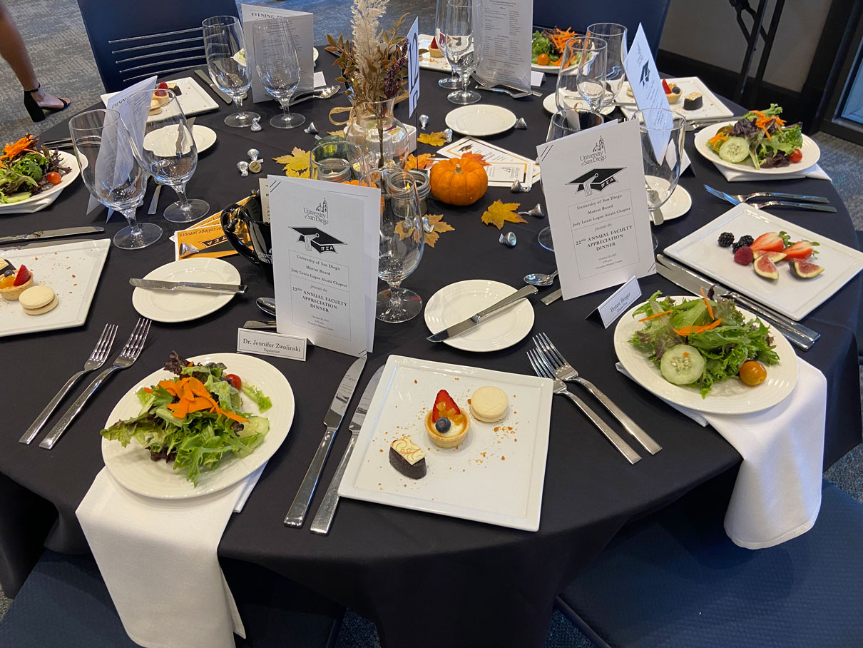 Table set with dinner and Mortar Board fliers