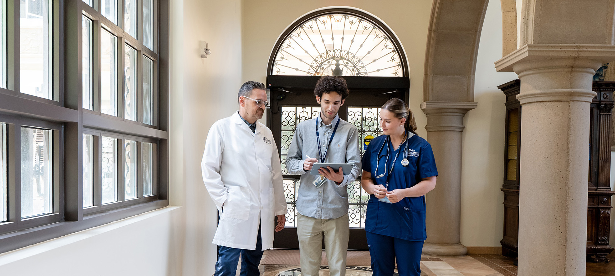 Informatics student with nursing students in entrance to BINR