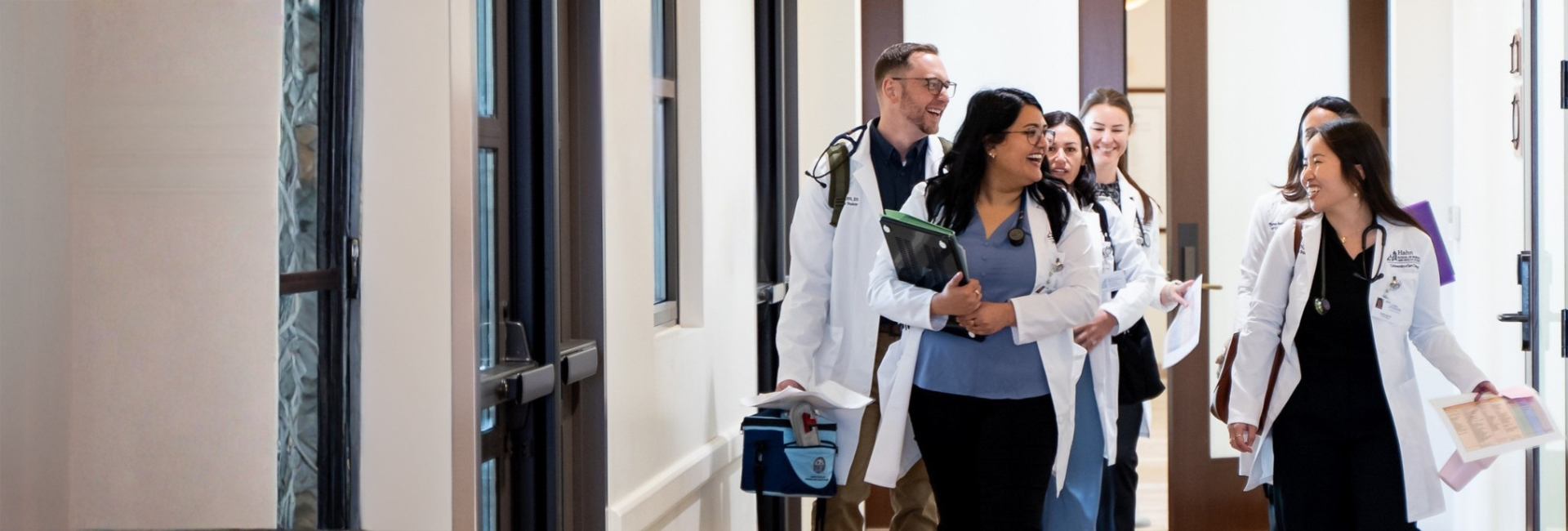 DNP FNP students walking and talking together in sim lab hallway