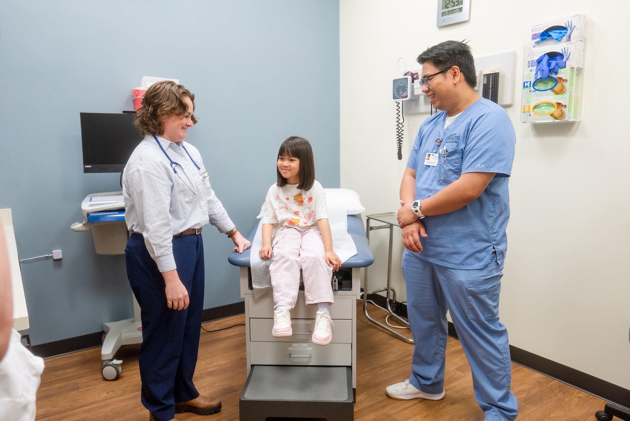 Pediatric nurse practitioner with child patient and RN