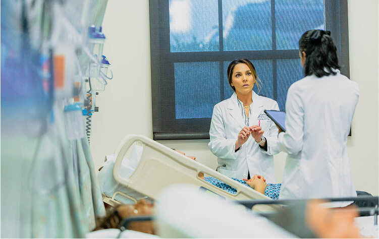 Students talking in sim lab