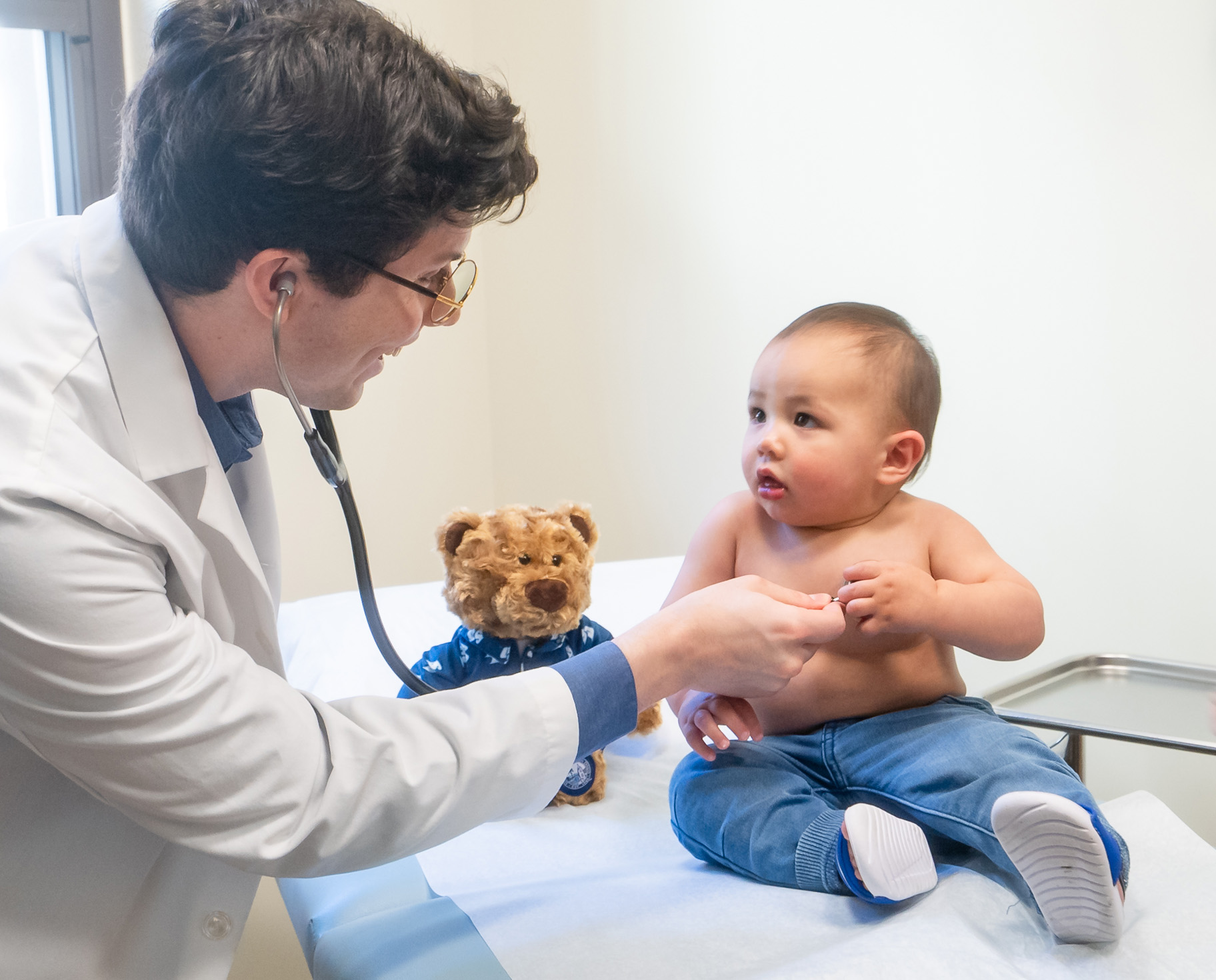 NP student examines baby patient with stethoscope