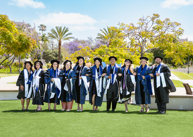group of PhD in nursing graduates on campus lawn