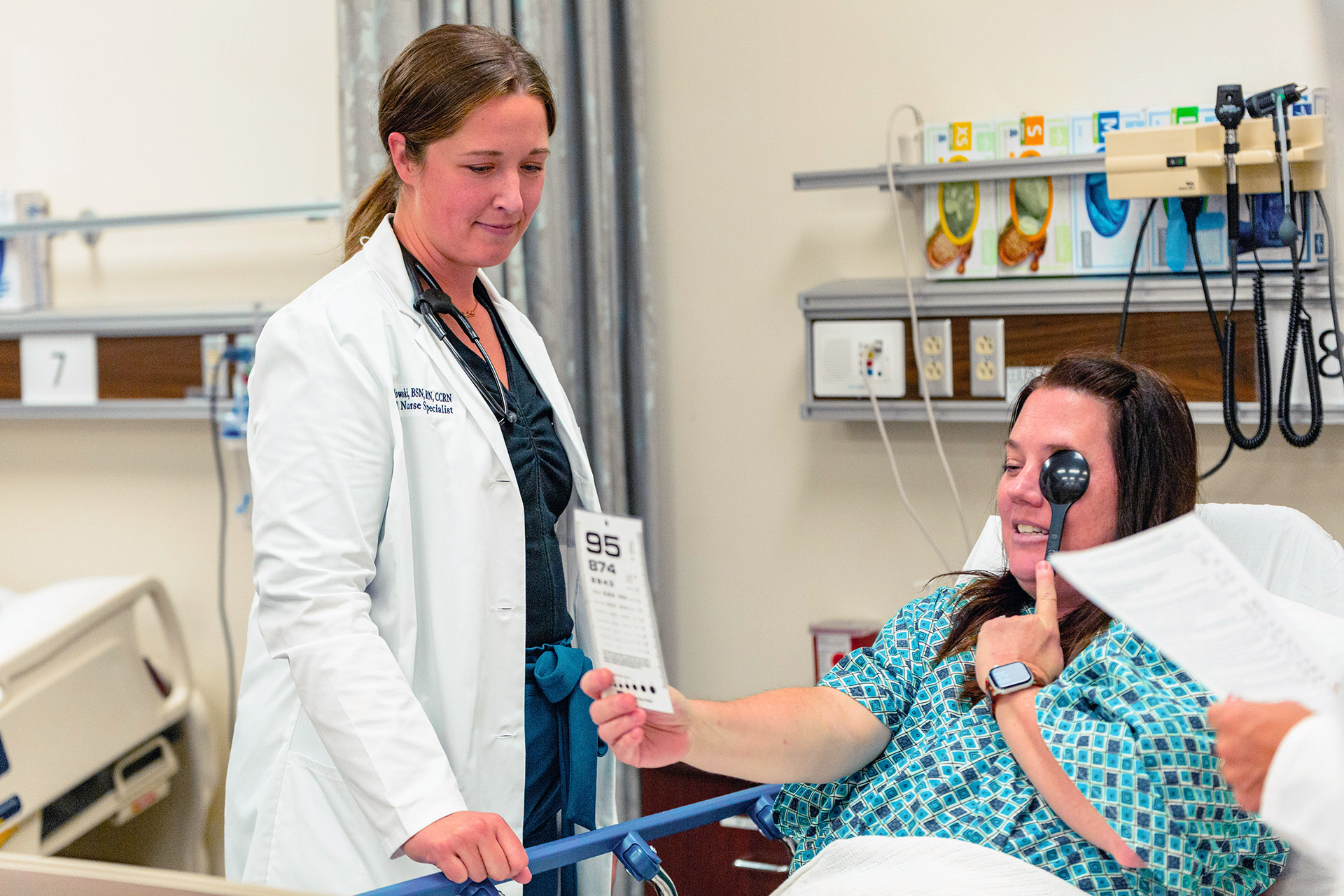 CNS student performing eye test on patient in sim lab