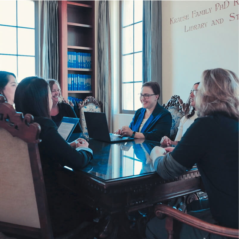 PhD students around table in school of nursing