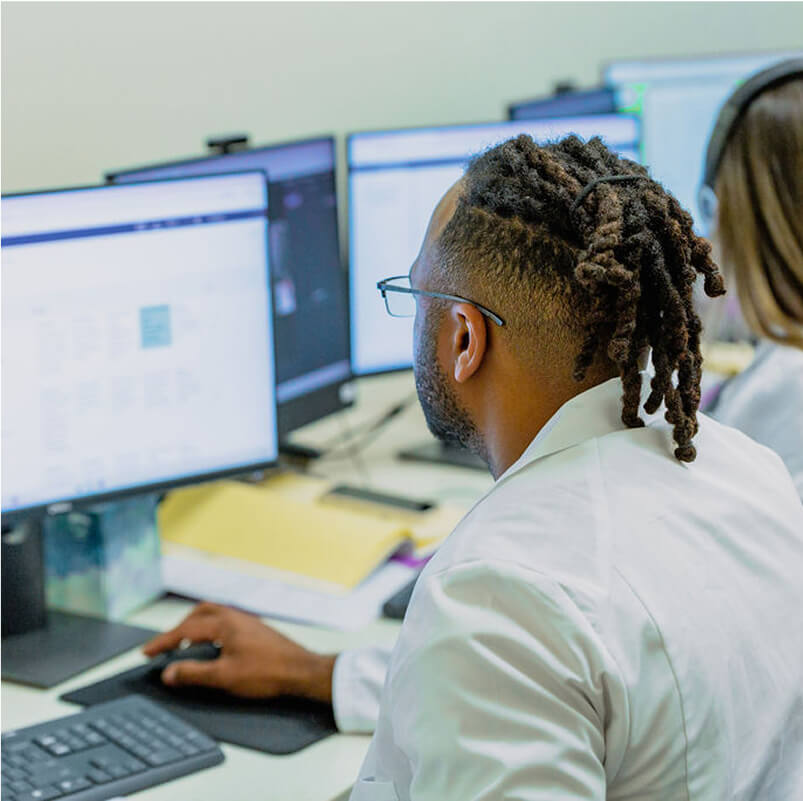 informatics student looking at computer monitor