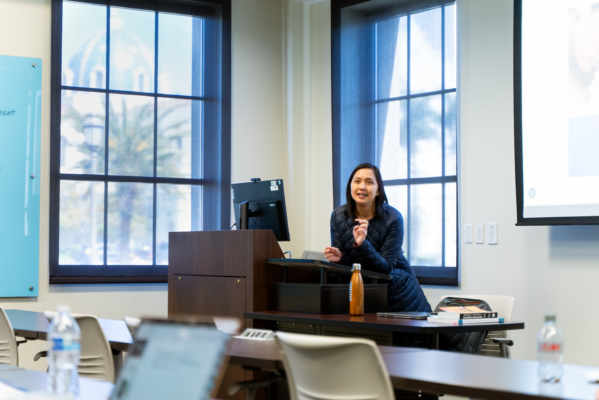 professor Theresa Nguyen at podium in nursing classroom