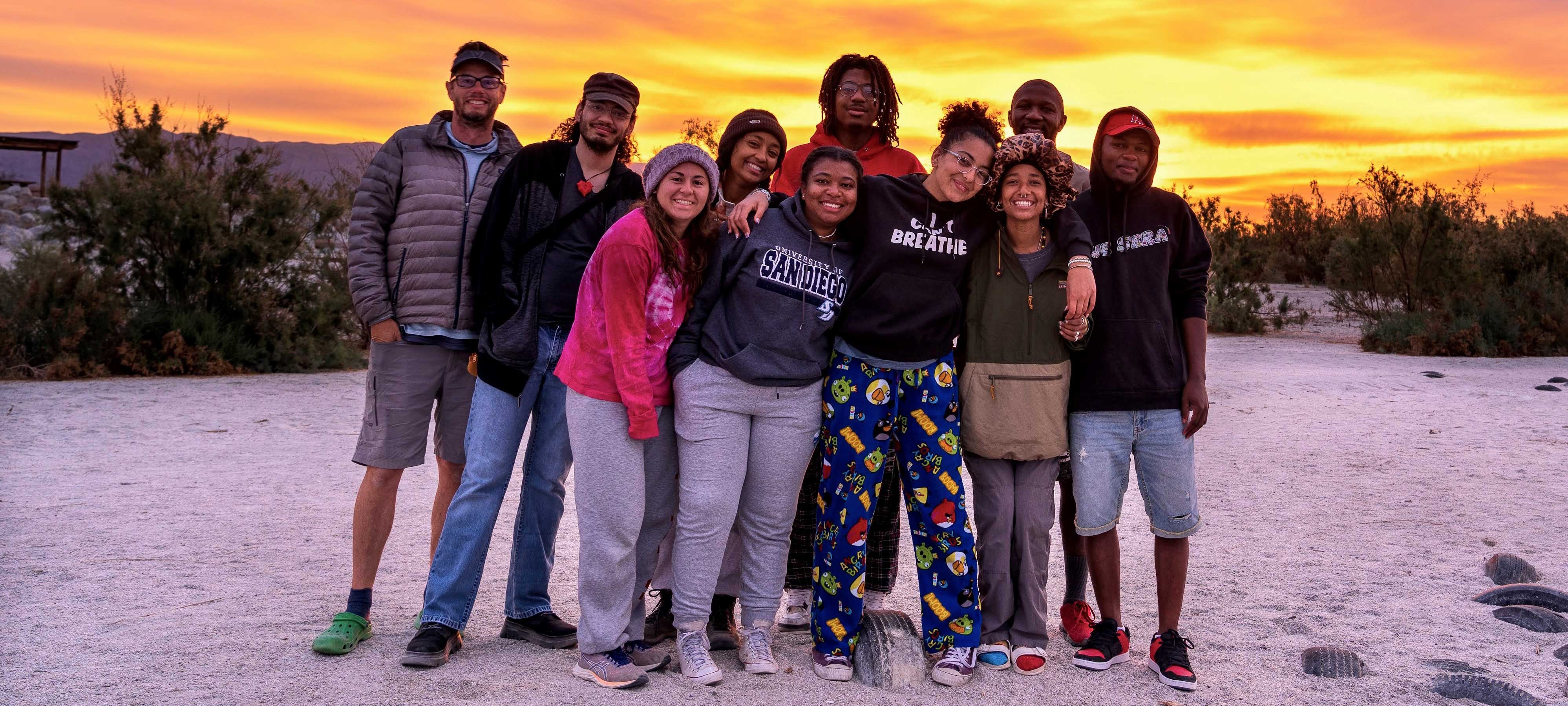 Group posing in front of sunset