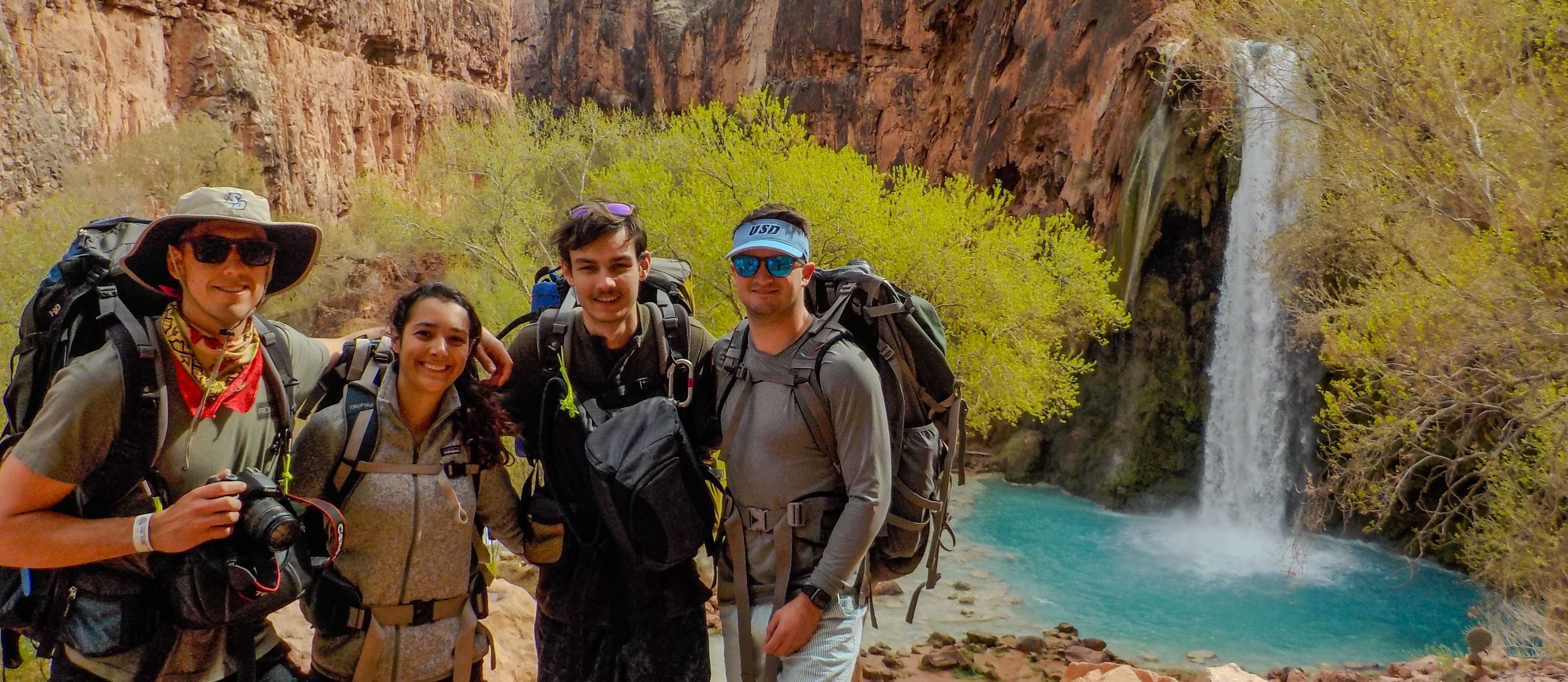 Students backpacking in front of Havasu Falls