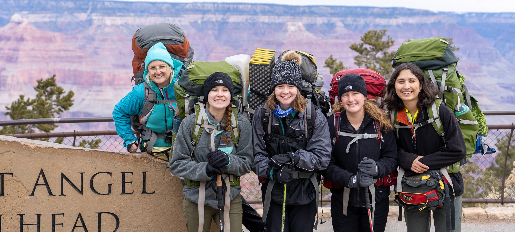 Group posing with backpacking equipment