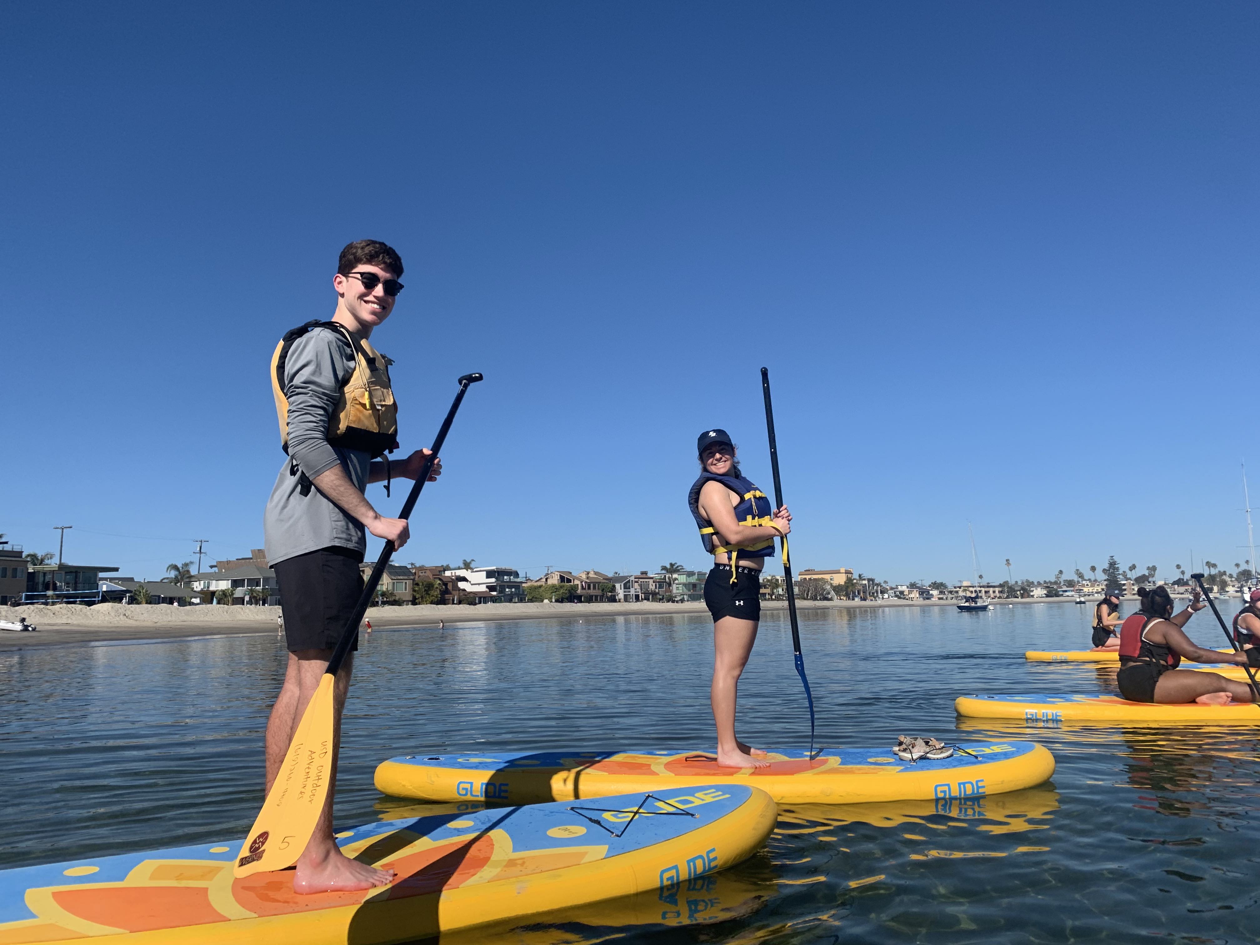 Students stand up paddle boarding