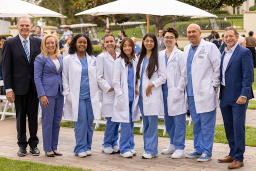 USD President James T. Harris and Palomar Health President and CEO Diane Hansen pose with Hahn School of Nursing and Health Science students. Photo: Alé Delgado