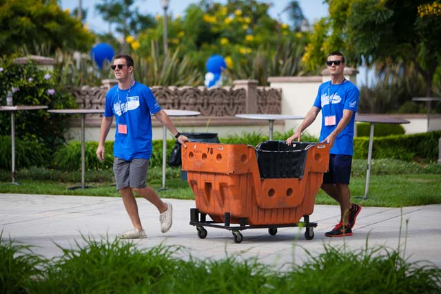Two volunteers moving cart