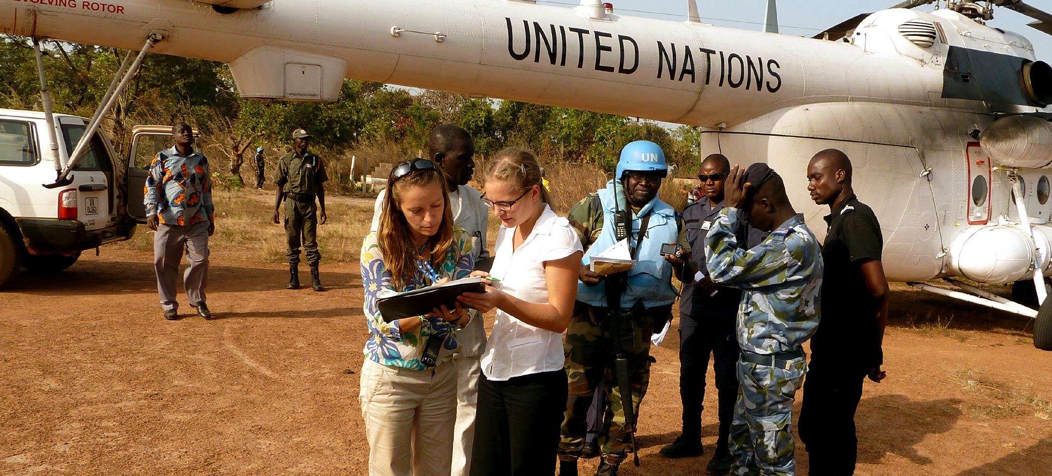 Students talking in front of a plane
