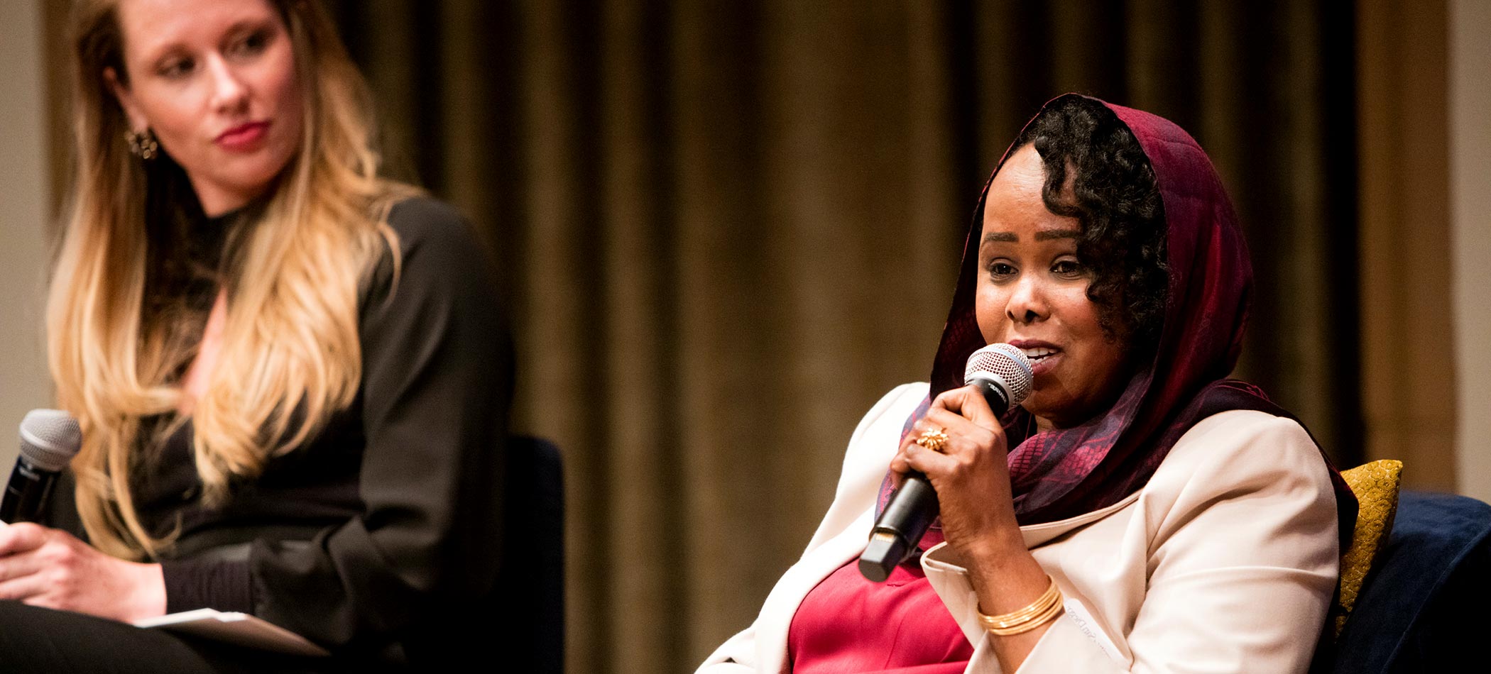 A woman peacemaker talks on stage