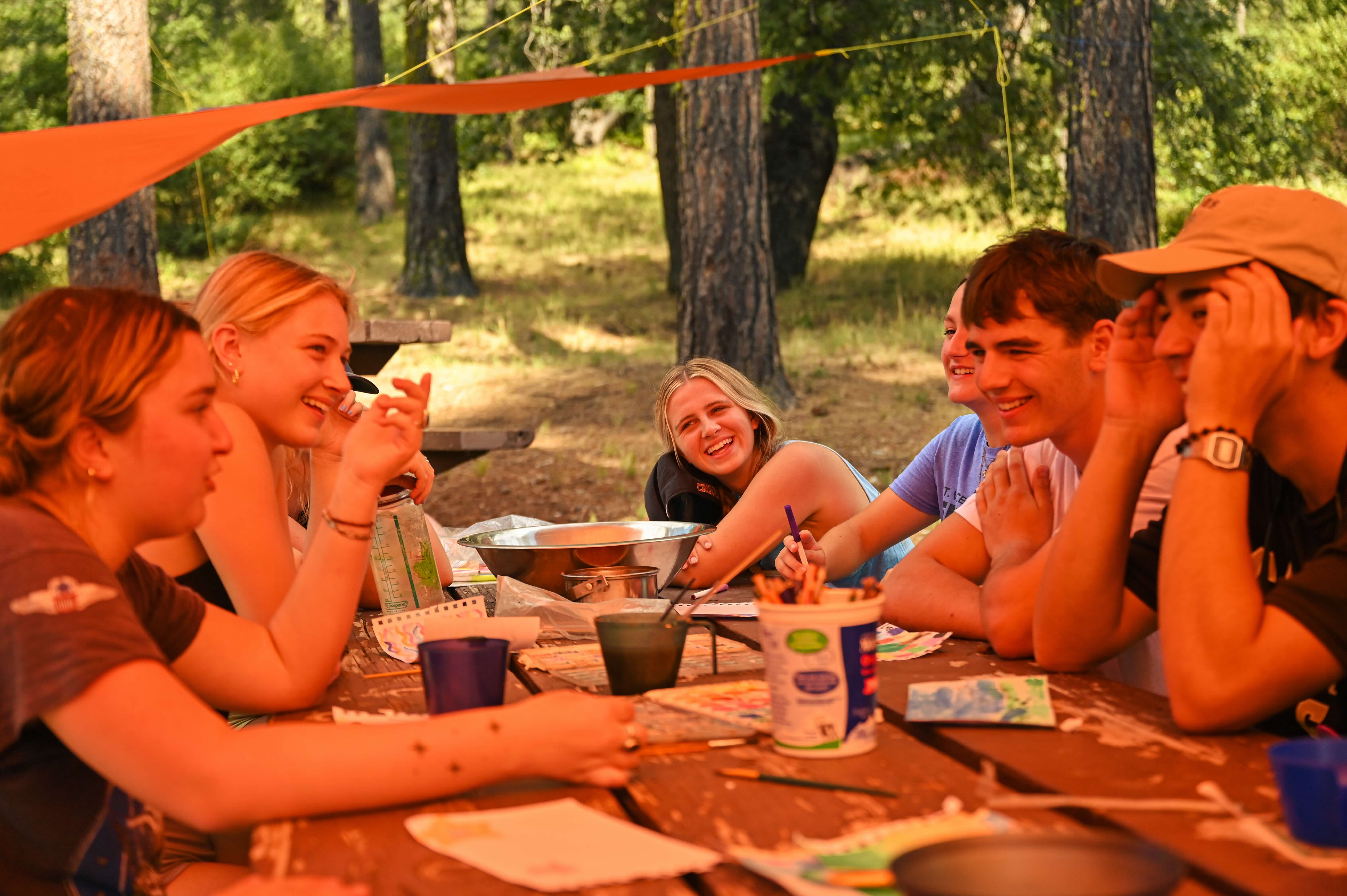 group of students painting and conversing