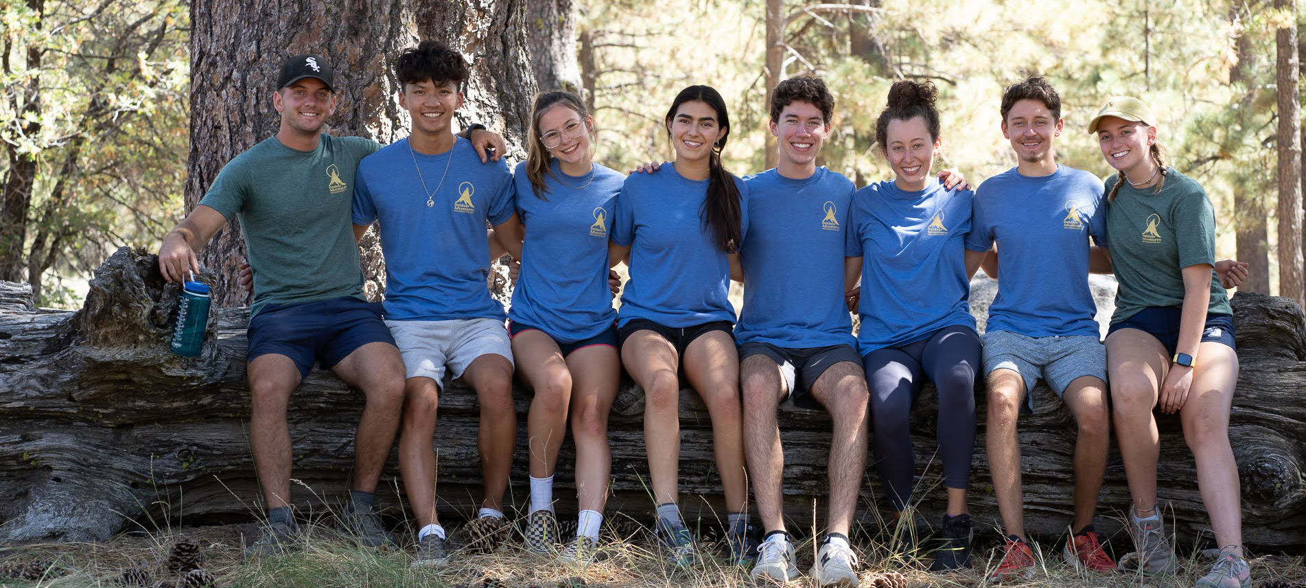 Group sitting on fallen tree trunk