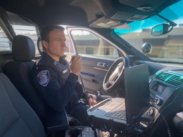 An officer working in his car