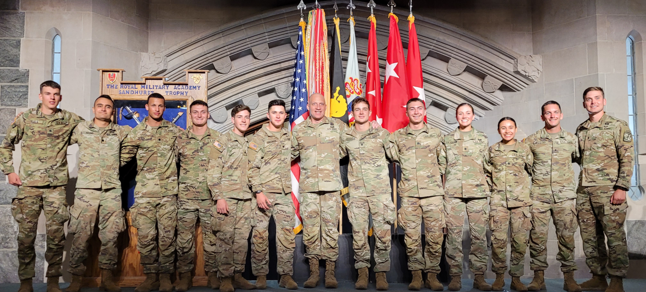 two army cadents walking outside of campus