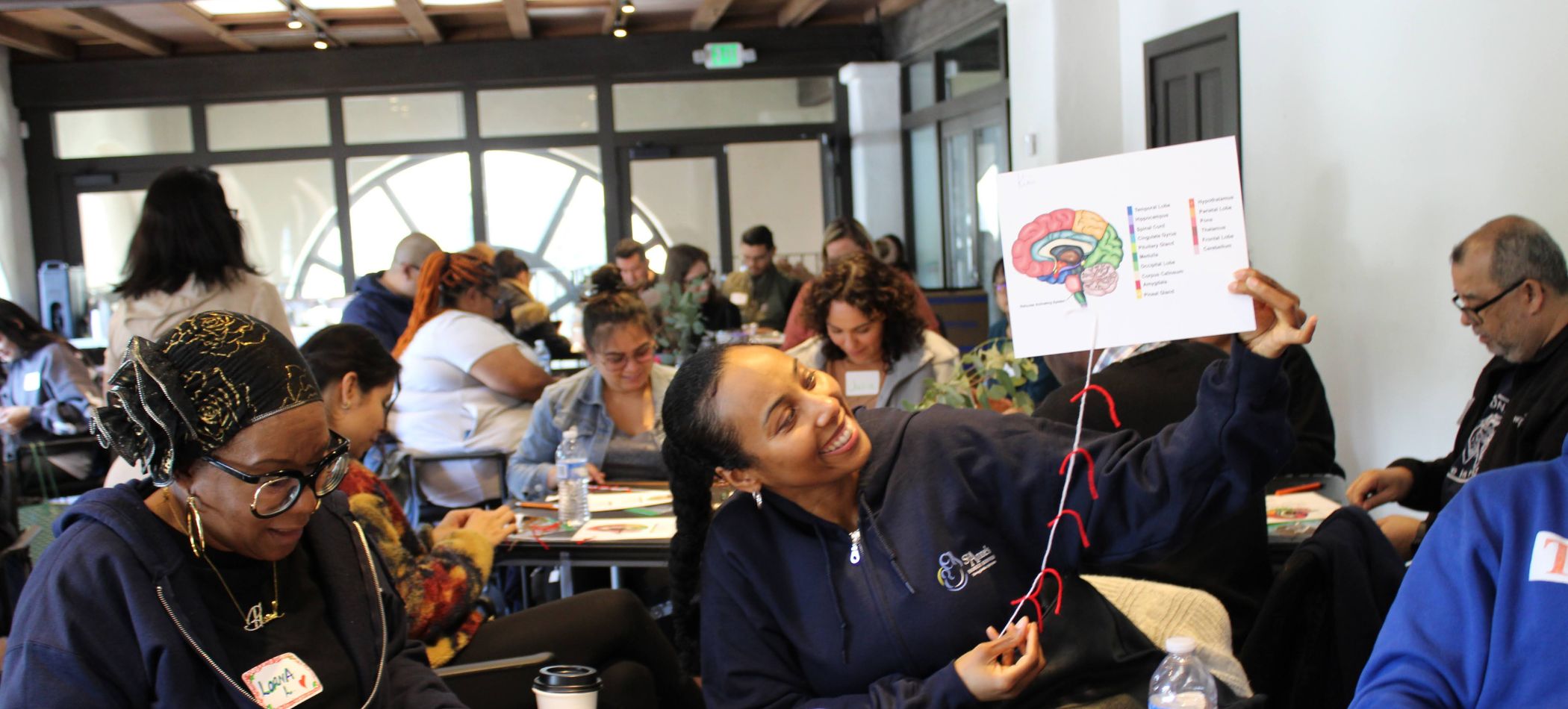 person holding up her art piece