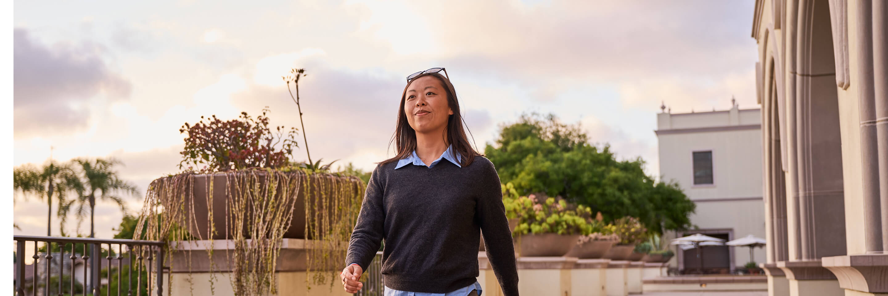 a woman confidently walking on campus