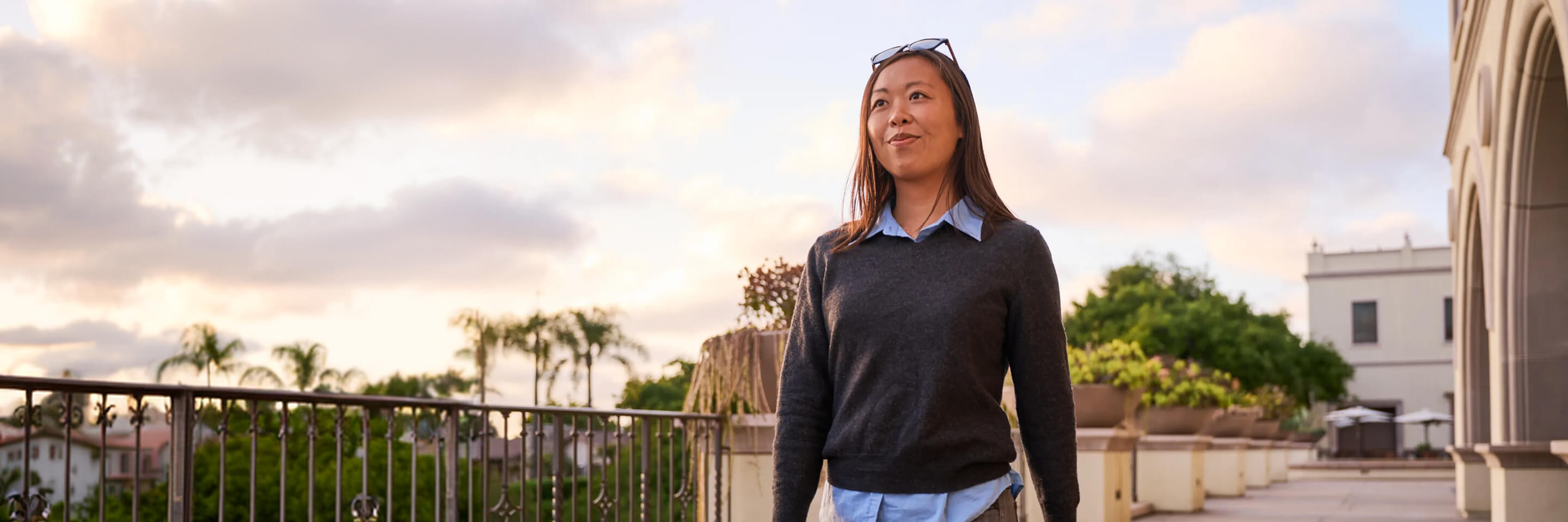 Portrait of confident female student walking on campus