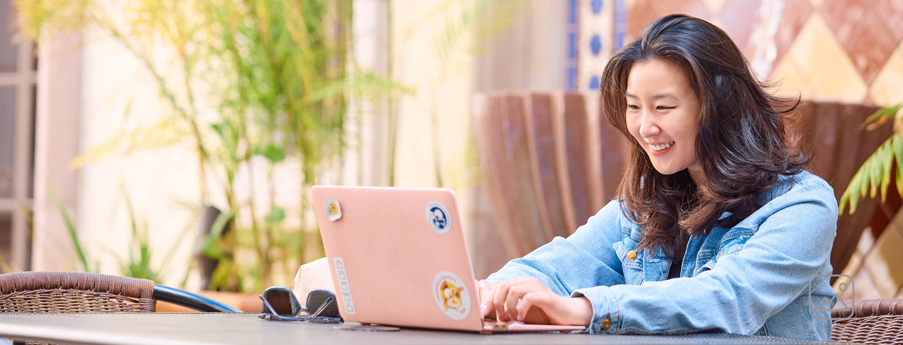 Student sitting outside on laptop