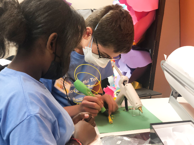 two female students building a robot