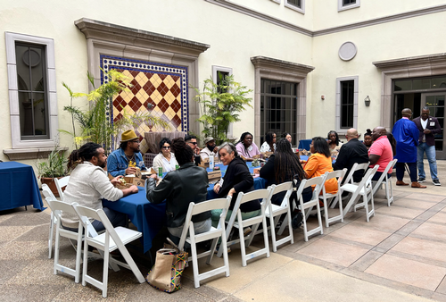 image of patio area with a table, people eating outside