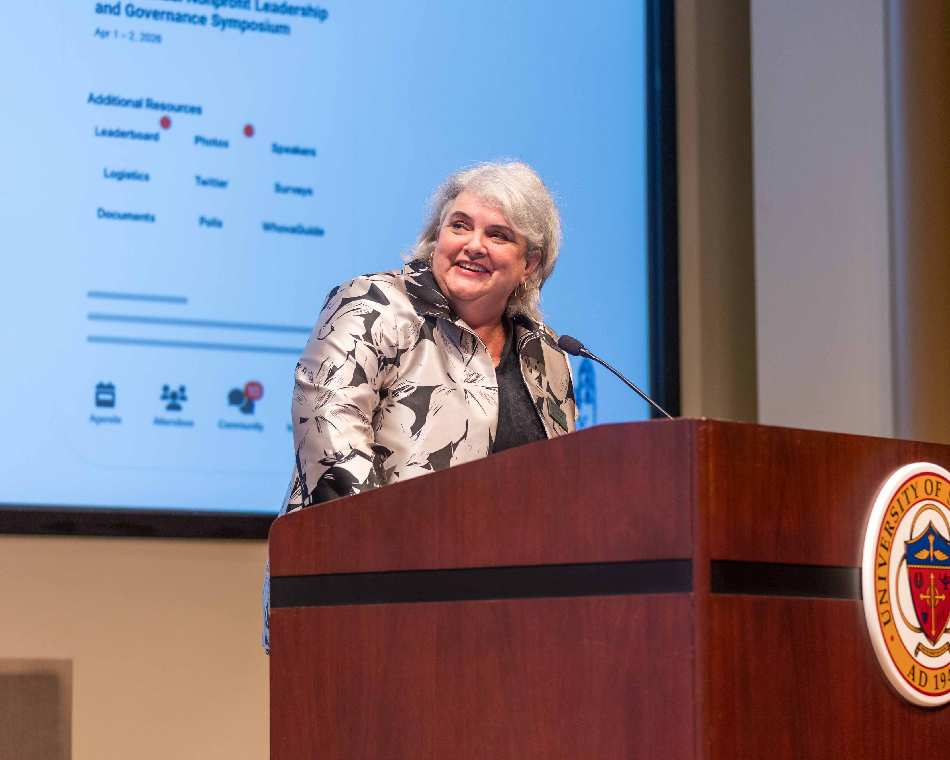 Laura Deitrick speaking at a podium.