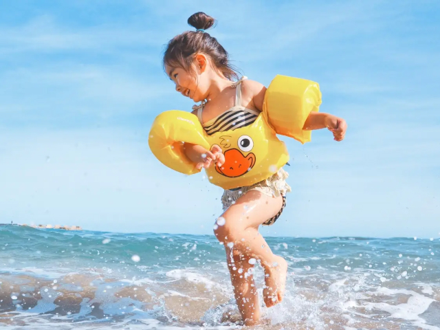 child playing at beach